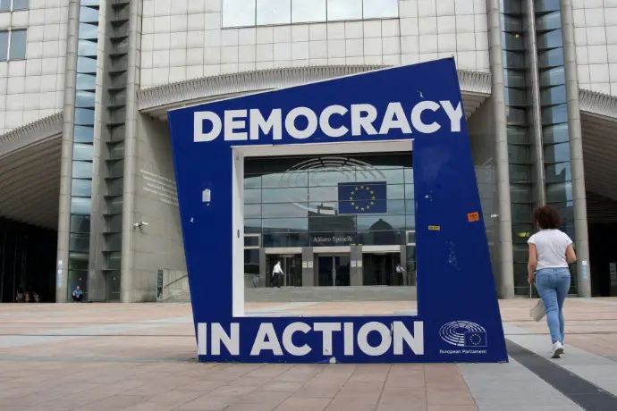 Large blue structure with "democracy in action" text.